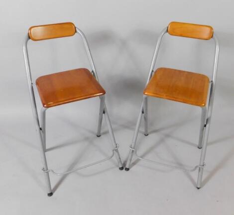 A pair of Ikea Dennis industrial style folding grey metal and wooden stools.