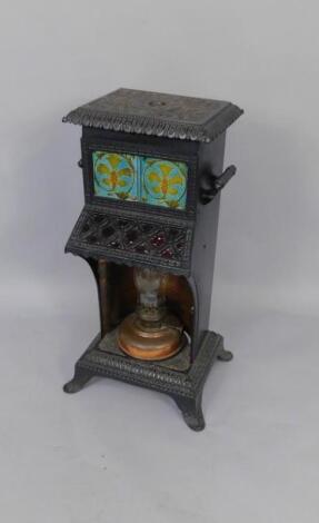 A Victorain black cast iron and tile inset cathedral heater