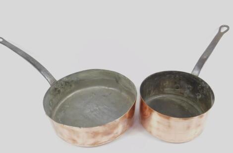 Two French copper saucepans with cast iron handles.