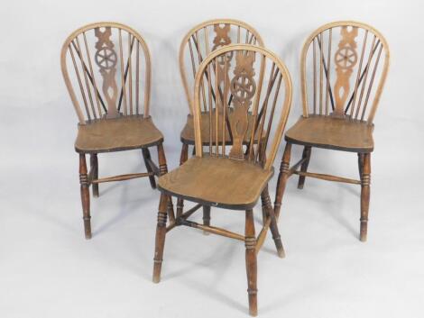 A set of four oak and elm wheelback kitchen chairs