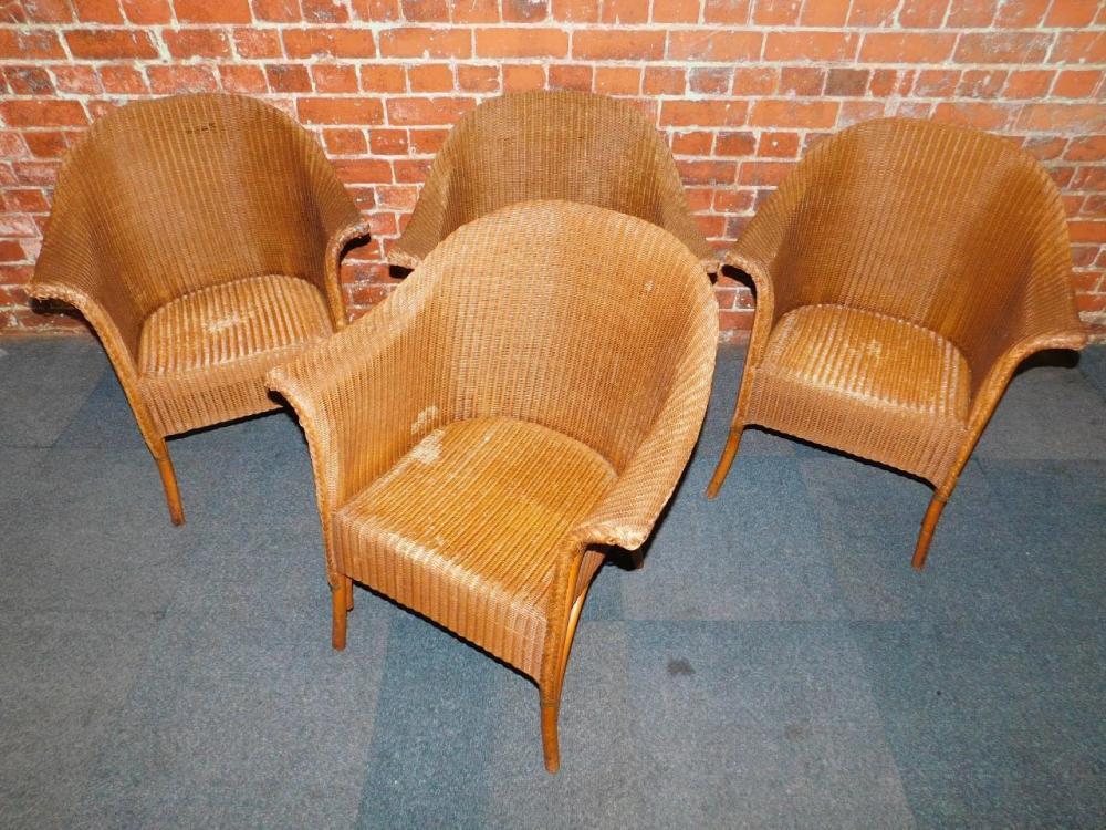 A set of four gilt Lloyd Loom Lusty tub armchairs. With a copy of