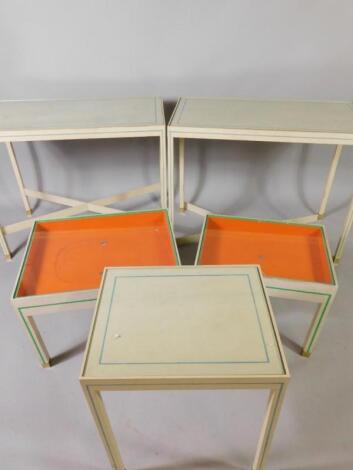 A pair of white painted graduated bijouterie tables