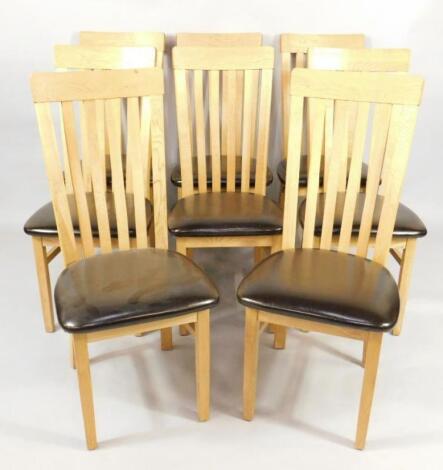 A set of eight light oak lath high back single dining chairs