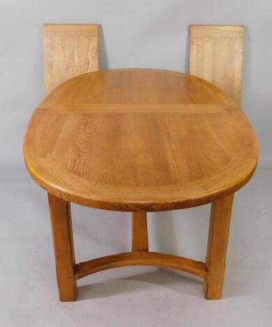 A light oak oval extending dining table