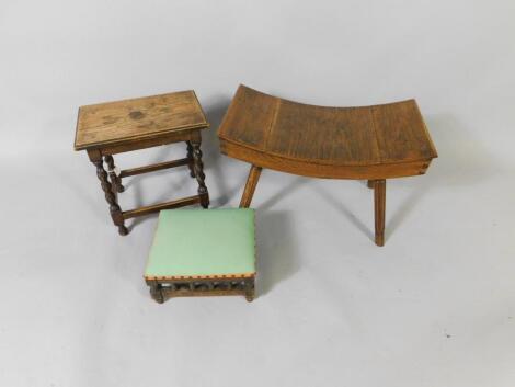 An oak stool with a curved seat