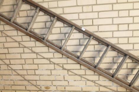 A wooden extending ladder.