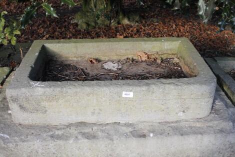 A rectangular stone hand hewn water trough