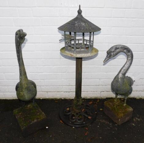 A cast metal bird feeder