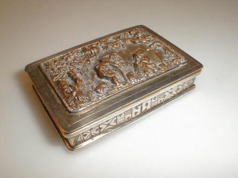 A white metal snuff box heavily embossed lid of figures and animals by