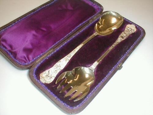 A pair of Victorian silver gilt servers by Henry John Lias & James Wakely