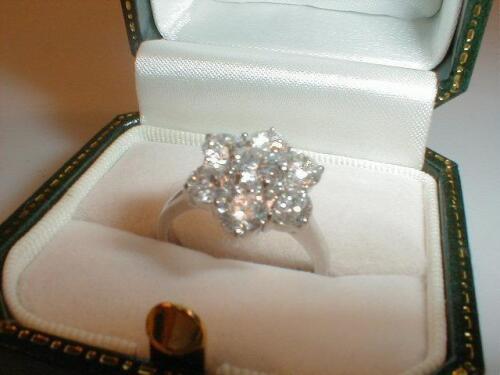 A floral cluster diamond ring of seven stones totalling approximately 2ct