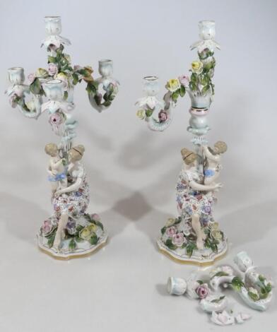 A pair of Continental porcelain Sitzendorf style candlesticks