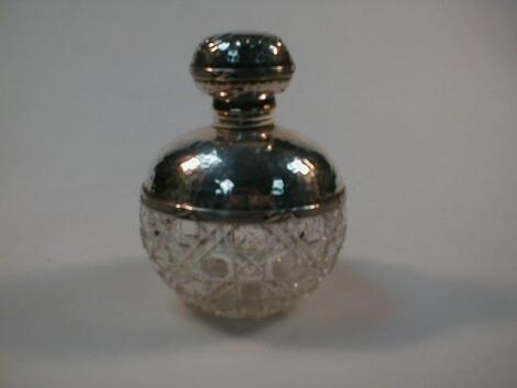 An early 20thC silver and cut glass scent bottle