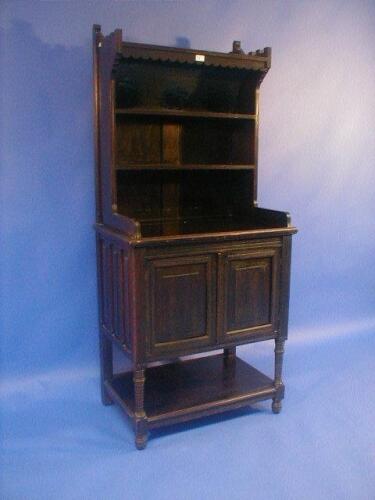 A late Victorian stained beech side cabinet with shelves over a two door