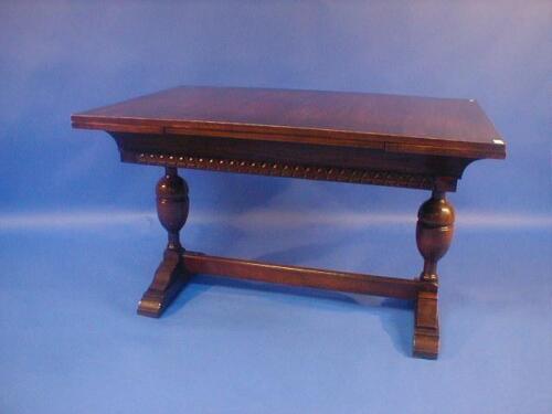 An oak refectory style drawer leaf dining table with bulbous legs and moulded stetcher