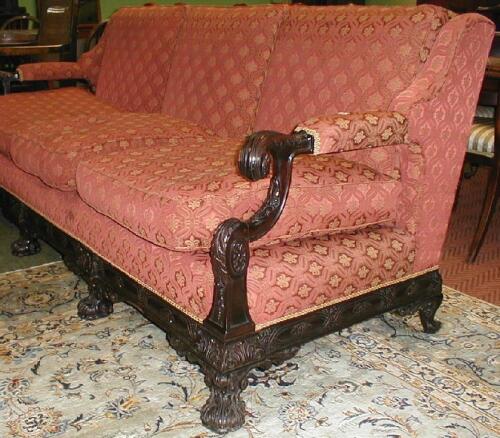 An early 20thC upholstered walnut framed three seater sofa