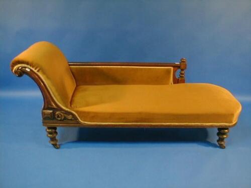 A Victorian oak framed chaise lounge upholstered in gold draylon