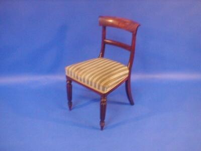 A set of four William IV mahogany bar back dining chairs with over run cresting rails