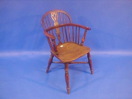 A 19thC yew low back Windsor chair with pierced vase splat