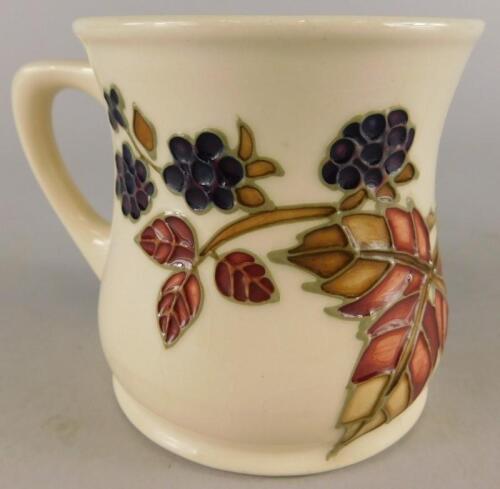 A Moorcroft pottery Bramble pattern mug