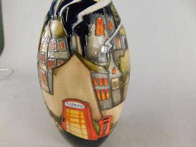 A Moorcroft pottery vase decorated with a village - 2