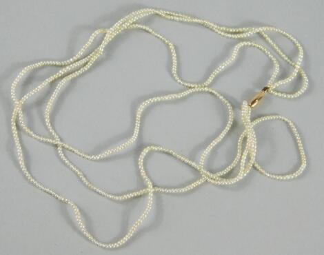 A dainty three strand seed pearl necklace