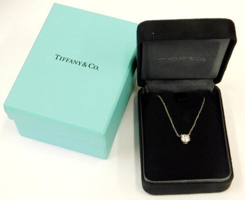 A Tiffany & Co solitaire diamond and platinum pendant