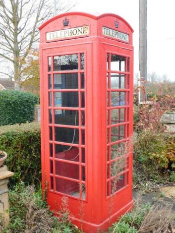 A red cast iron telephone box.