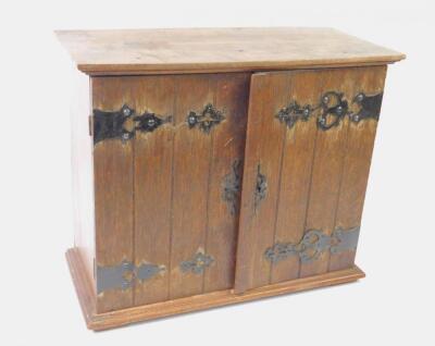 An Edwardian oak table cabinet