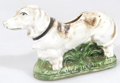 A 19thC pottery figure of a dog