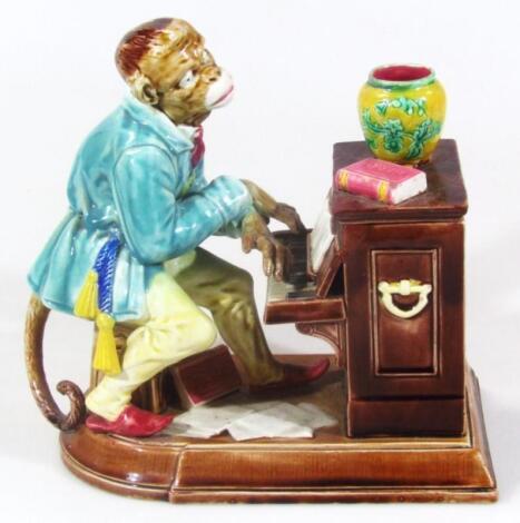 A late 19thC Sarreguemines majolica monkey and piano group