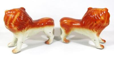 A pair of very early 20thC pottery figures of lions - 2