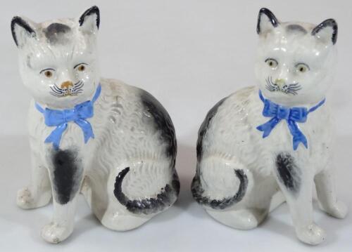 A pair of Staffordshire pottery cats