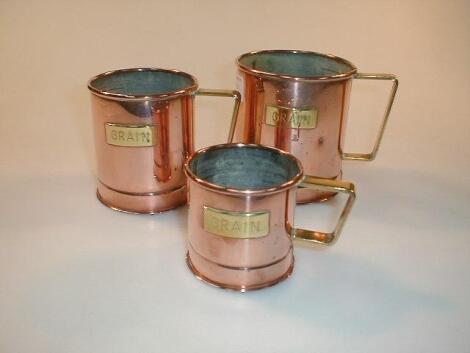 A set of three early 20thC graduated copper grain measures