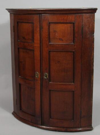 A late 18thC oak corner cupboard