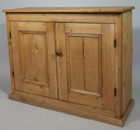 A stripped and lightly polished pine side cabinet