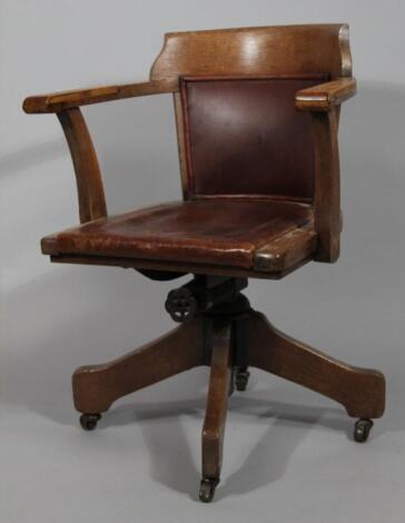 A 1930s oak office swivel chair