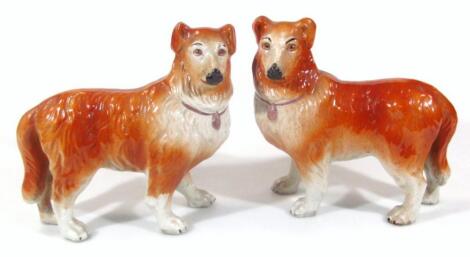 A pair of late 19thC pottery figures of standing collies