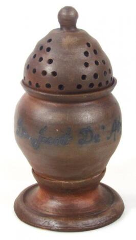 A brown stoneware jar and cover