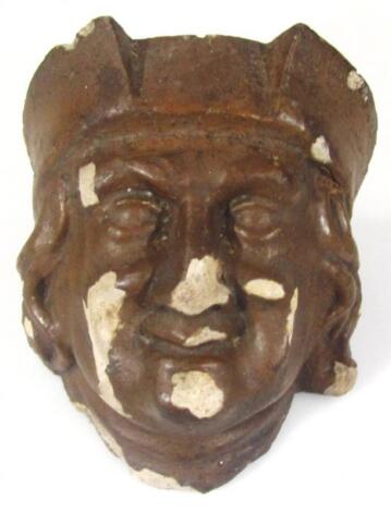 A heavily carved stone terracotta finish drain hopper head wall mask