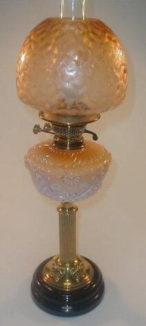 A Victorian oil lamp, with an opaque peach glass moulded reservoir supported