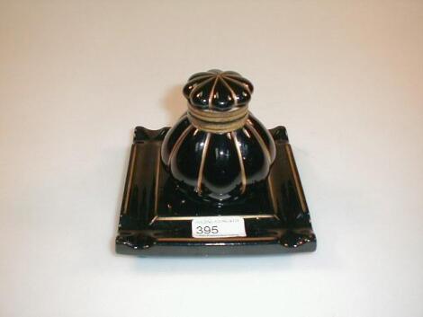 A late 19thC black-ground ceramic desk stand