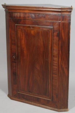 A very early 19thC mahogany hanging corner cupboard