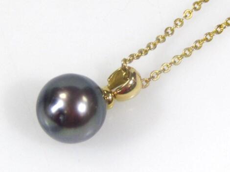 A dark green pearl pendant