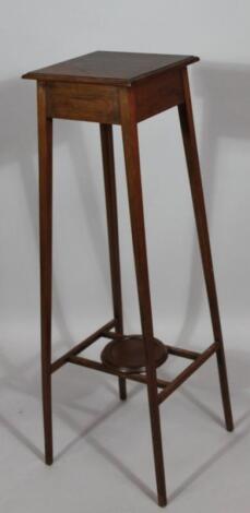 An Edwardian mahogany plant stand