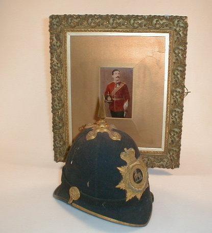 An officer's blue cloth helmet with gilt badge of The Royal Warwickshire Regiment