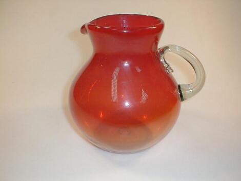 A large Ambrina red/orange jug with rolled clear handle