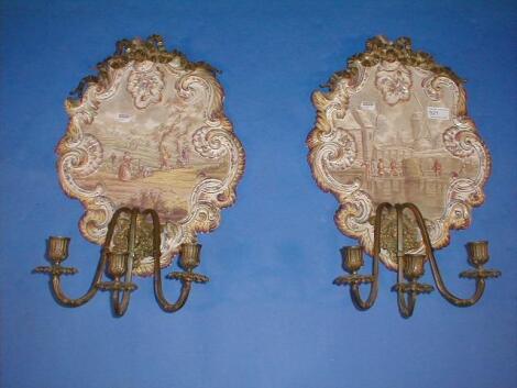 A pair of 19thC French porcelain girandoles of rococo scrolling design