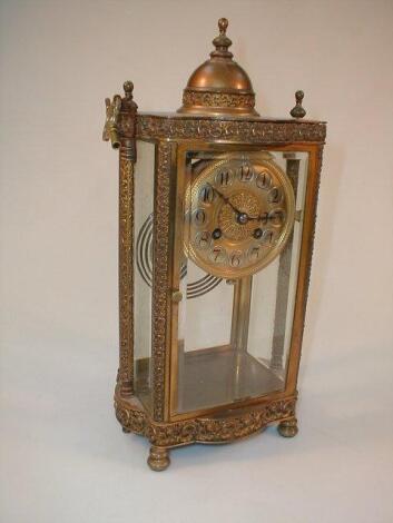 A gilt metal four glass table clock with Arabic numerals