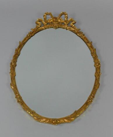 An oval gilt wall mirror